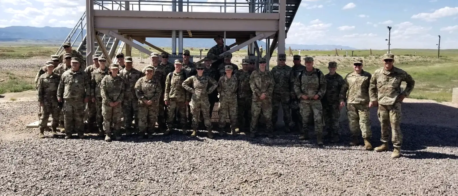 Colonel Braswell with a formation of soldiers at a training site